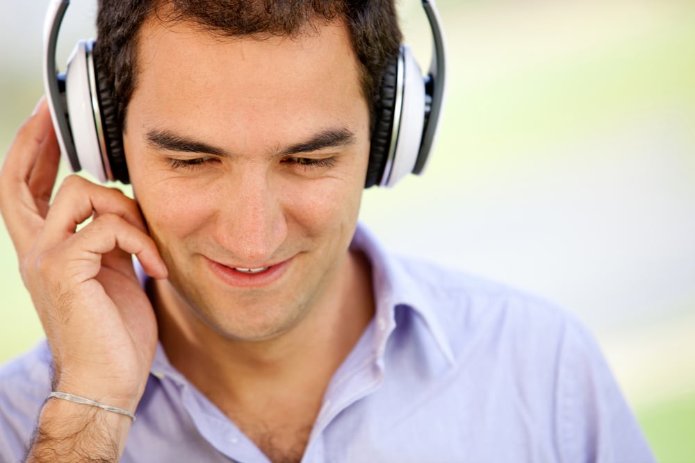 Man with headphones listening to music outdoors
