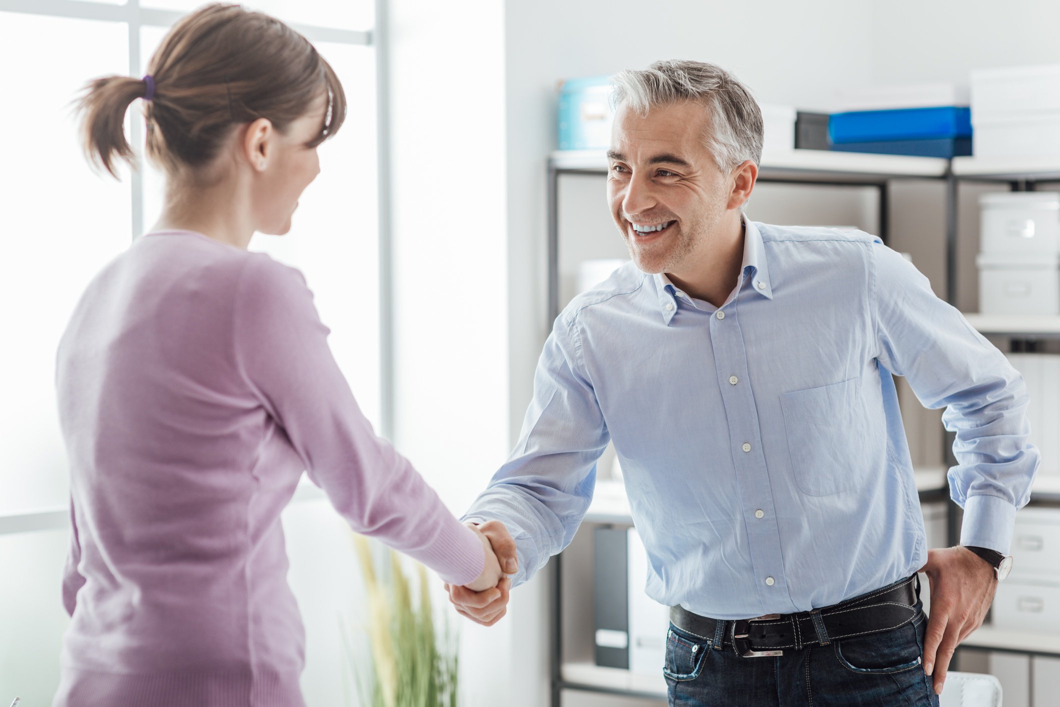 two accounting professionals shaking hands